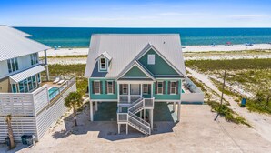 A two-story house with a balcony, a swimming pool, and a view of the beach and ocean. - Sunset Dreamer- Beachfront MB Home- Priv. Pool, Pet Friendly, Hot Tub, Sleeps 13 (Mexico Beach)
