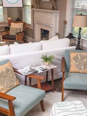 Relax in this inviting living room with a fireplace, comfortable seating, and a cozy atmosphere.