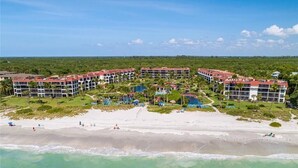 A resort with multiple buildings, a central pool area, and a beach. - Beautiful Pointe Santo Overlooking Gulf (Sanibel)