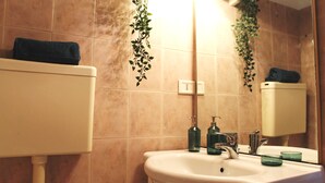 A bathroom with a sink, mirror, and toilet.