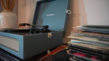 A turntable with a record on it, placed on a wooden surface.