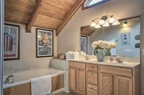 Bathtub, hair dryer, towels, toilet paper