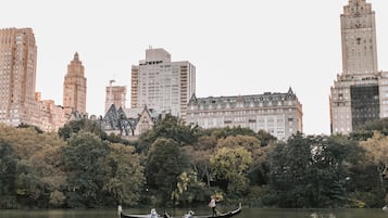 A gondola on a lake with buildings in the background.