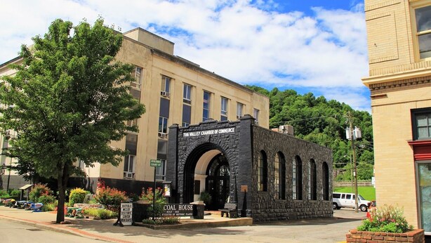 A historic building with a stone archway labeled "Tug Valley Chamber of Commerce" and "Coal House." - Turkey Creek Retreats  (Belfry)
