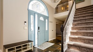 A staircase with a carpeted floor leading to a landing.