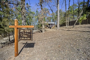 A sign for 'Little Dipper Cabin' with a split shotgun circle logo.