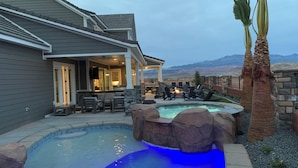 A backyard with a swimming pool, patio furniture, and a stone wall. - New | Family Reunions | Corporate Retreats | Private Pool |  Sleeps 23 (Washington)