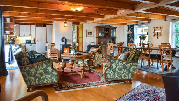 A cozy living room with wooden floors, a fireplace, and traditional furniture. - 7 bedroom awesome home in örkelljunga (Örkelljunga)