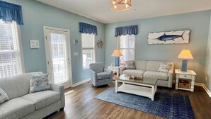 A living room with a sofa, armchair, coffee table, and lamps. - 5-Star*Sunset Island Townhouse, close to POOLS, Beach Chairs, FREE Linens/Towels (Ocean City)