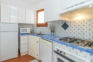 Family Apartment, Multiple Bedrooms, 2 Bathrooms (Erica Primo Piano 150m From the Beach) | Private kitchen | Fridge, microwave, oven, stovetop - Appartamenti Erica (Golfo Aranci)