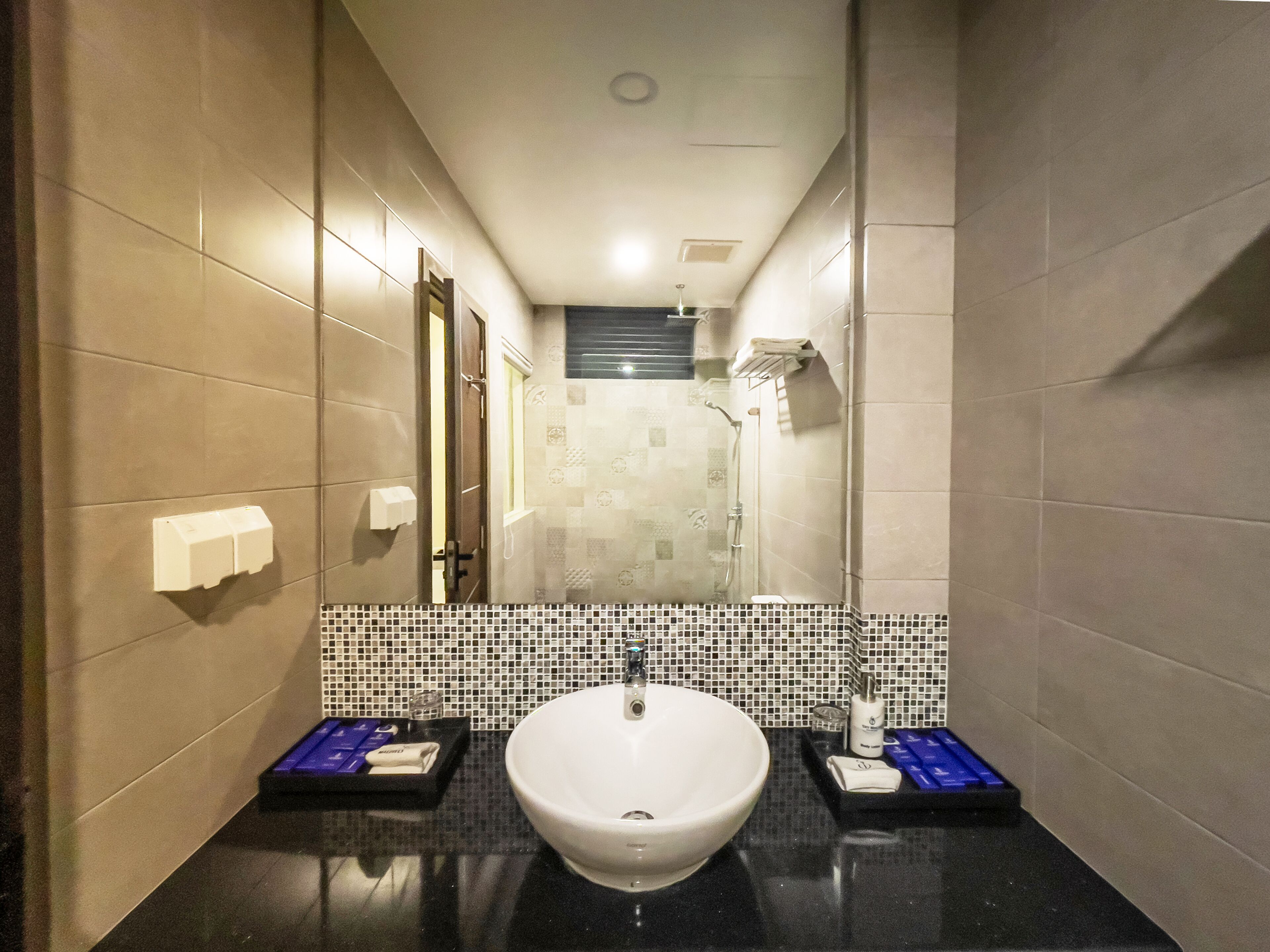 Un baño con un lavamanos grande, un espejo y una ducha.