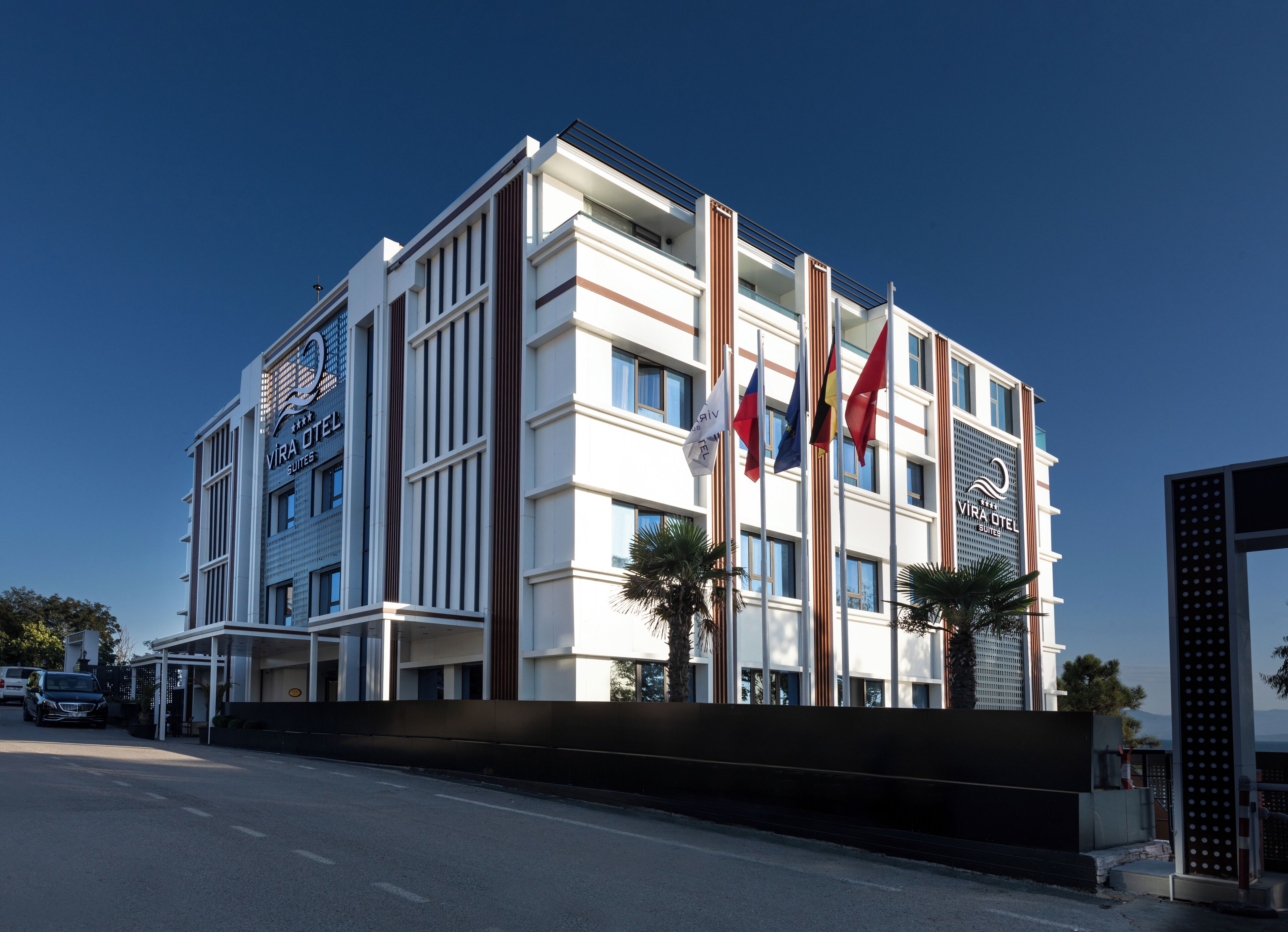 Un moderno edificio de hotel con varios pisos, ventanas amplias y una entrada destacada.