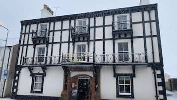 A traditional building with a sign reading "Kings Arms Hotel".