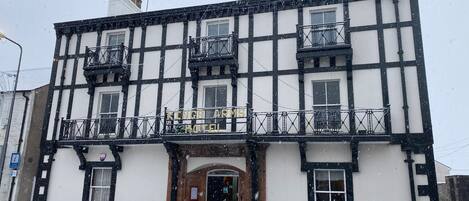 A traditional building with a sign reading "Kings Arms Hotel".
