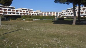 A modern building with a unique architectural design featuring multiple balconies and a central courtyard.