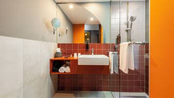Ein modernes Badezimmer mit Waschbecken, Spiegel und Dusche.