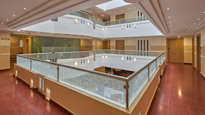 A multi-level atrium with glass railings and a central open space.