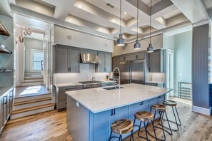 Enjoy cooking in this well-lit kitchen with a large island and stainless steel appliances.