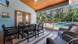 A covered patio with a pool, wooden ceiling, and outdoor furniture. - ⚓Private pool home-Boat Dock-Arcade Games!⚓🌅 (Bradenton)