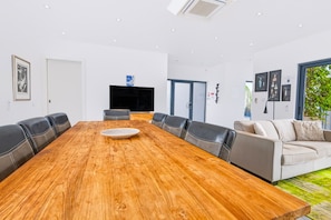 A modern conference room with a wooden table, leather chairs, a flat-screen TV, and a sofa. - Casa Blanca Magnificent Villa With Modern Design, walking distance to beach (Carvoeiro)