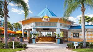 A restaurant with a distinctive blue roof and a sign reading "Warcola Grill".