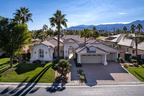 A single-story house with a tiled roof, a garage, and a well-maintained lawn. - Contemporary and Extensive outdoor Living South Facing Outdoor Paradise! (LA QUINTA)