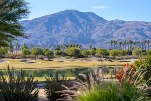 A golf course with a mountain backdrop, a pond, and various trees. - Contemporary and Extensive outdoor Living South Facing Outdoor Paradise! (LA QUINTA)