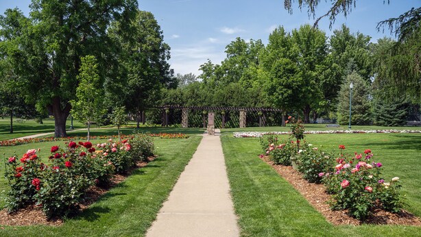 A pathway leading to a gazebo surrounded by well-maintained flower beds and trees. - Historic Mc Kennan Park Apt 2 (1 bed 1 bath) - KP220APT2 (Sioux Falls)