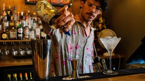 A bartender pouring a drink into a martini glass. - St Christopher's Vienna - Hostel (Vienna)