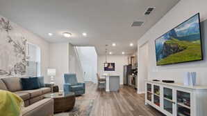 A modern living room with a sofa, armchairs, a coffee table, and a TV. - PROMO: BSV_1707Fireworks! 6BR Villa  - by Blue Sky Villas (Davenport)