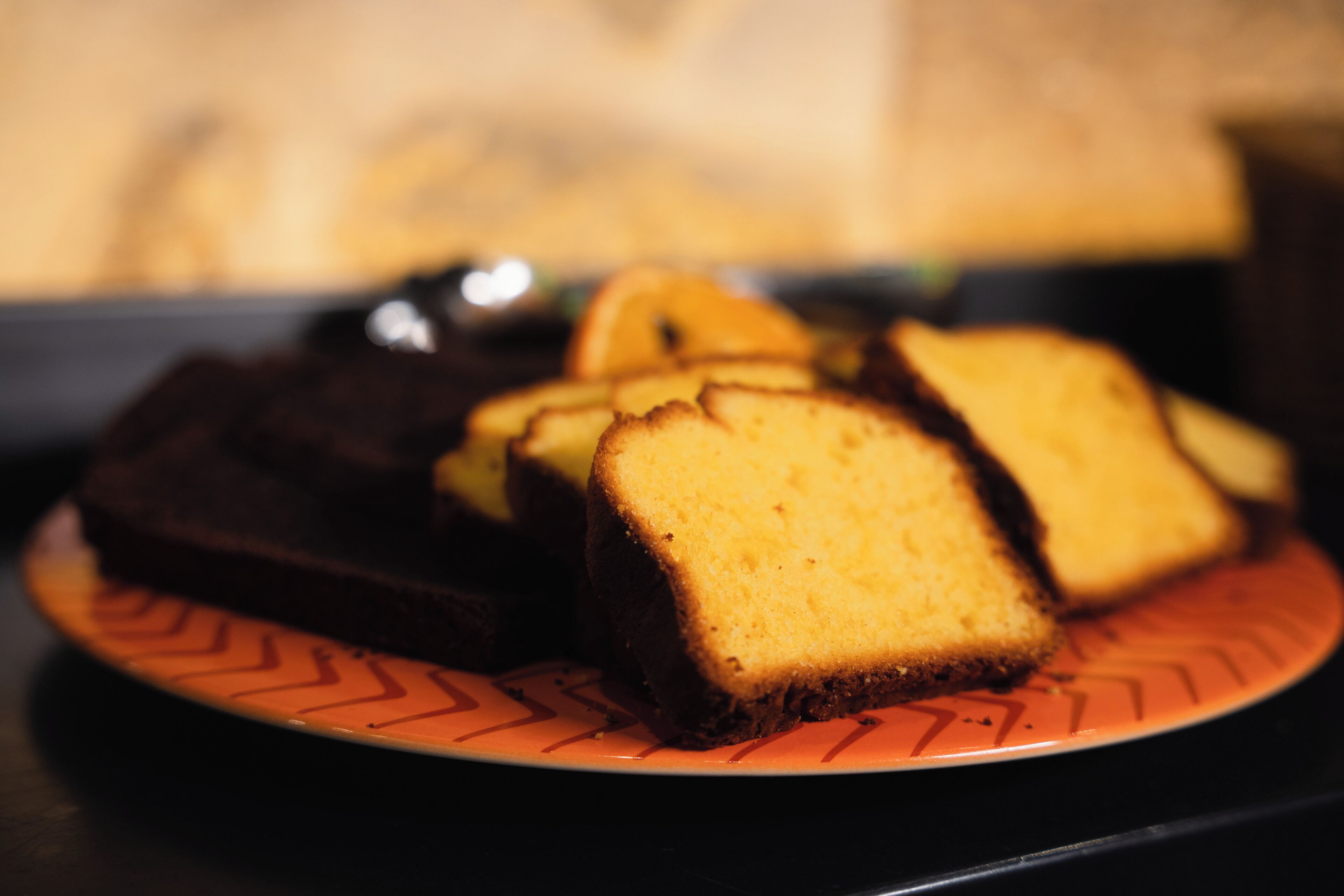 A plate with slices of cake on a patterned plate.