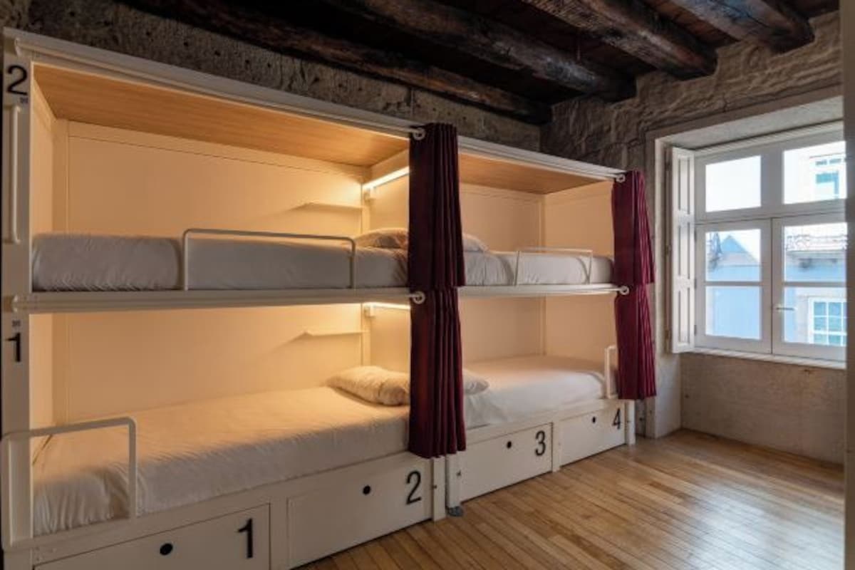 A room with four bunk beds, each marked with a number from 1 to 4.