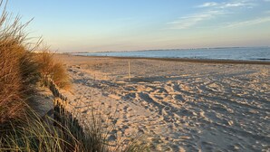 A sandy beach with a clear sky and distant shoreline. - T.2 SUPERB SEA VIEW "COCOONING FAVORITE" CLASS 2 STARS!!!! (La Grande-Motte)
