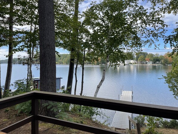 A lakeside view with a dock and a building in the background.