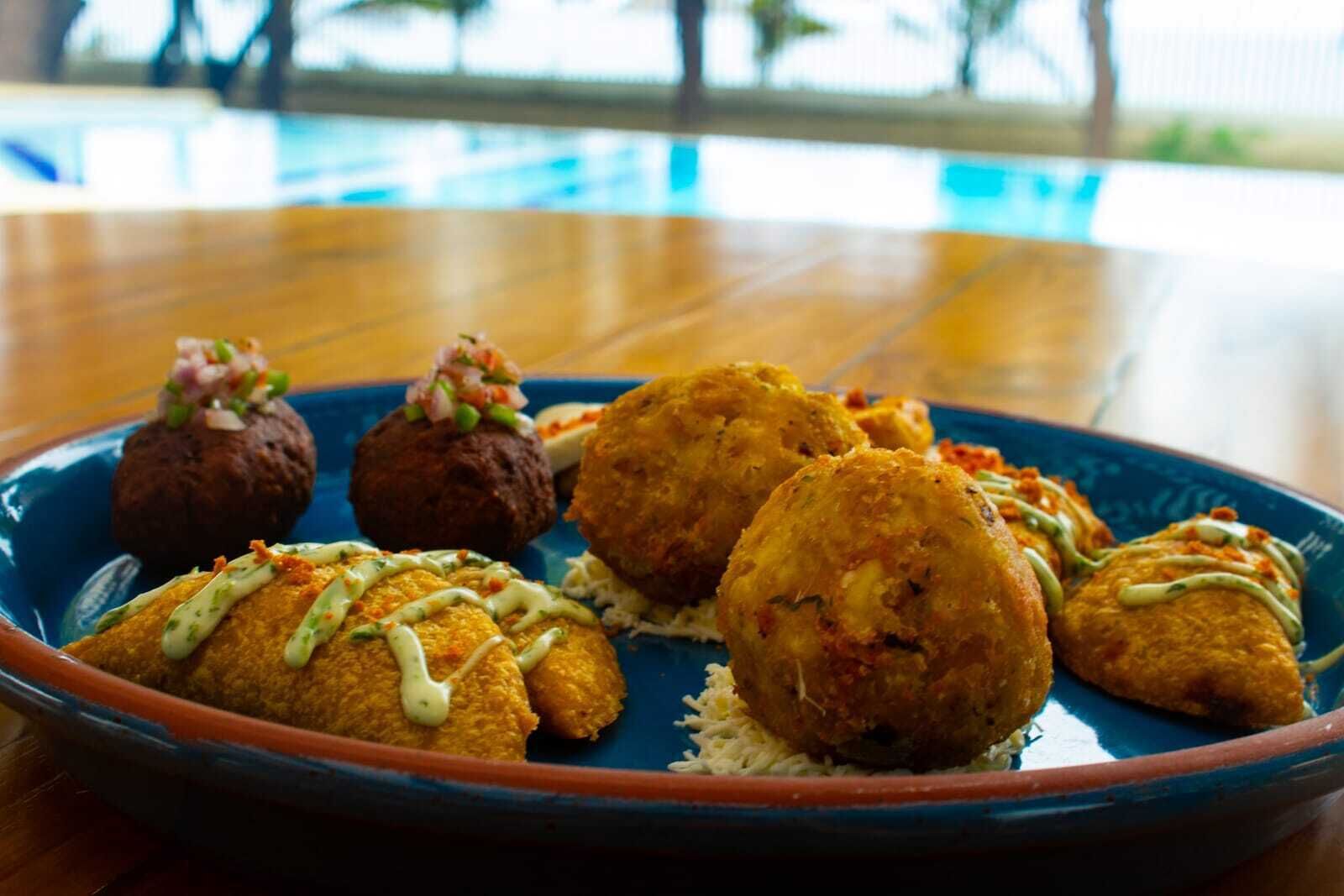 A plate of fried food with a blue rim, served on a wooden table.