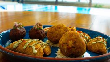 A plate of fried food with a blue rim, served on a wooden table.