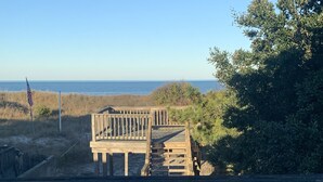 A wooden deck leading to a beach area with a view of the ocean. - Mermaid's and Mutts Retreat - Beach Front, Pet Friendly, Wi-Fi, Off-Street Park (Norfolk)