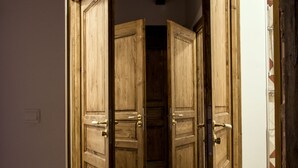 A hallway with wooden doors and tiled flooring. - Restored farmhouse, fenced garden 1.8 Ha, private swimming pool (Orthevielle)