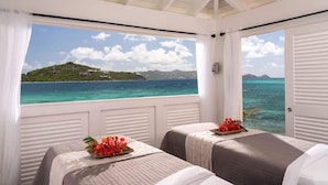 A room with two beds, a window with a view of a tropical island and turquoise waters. - Ritz-Carlton Club® / 2 Bed Lux Suite* (Fri to Fri) (St Thomas)