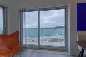 Enjoy a serene sea view from the large window, paired with a comfortable space for relaxation and dining.