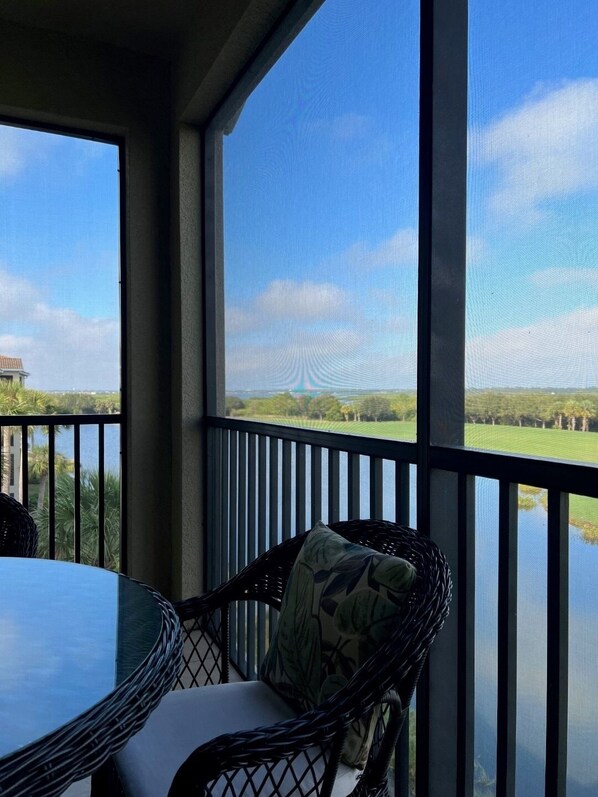 A room with a large skylight, a hammock, and a view of a green landscape. - TOP FLOOR CORNER CONDO (Bradenton)