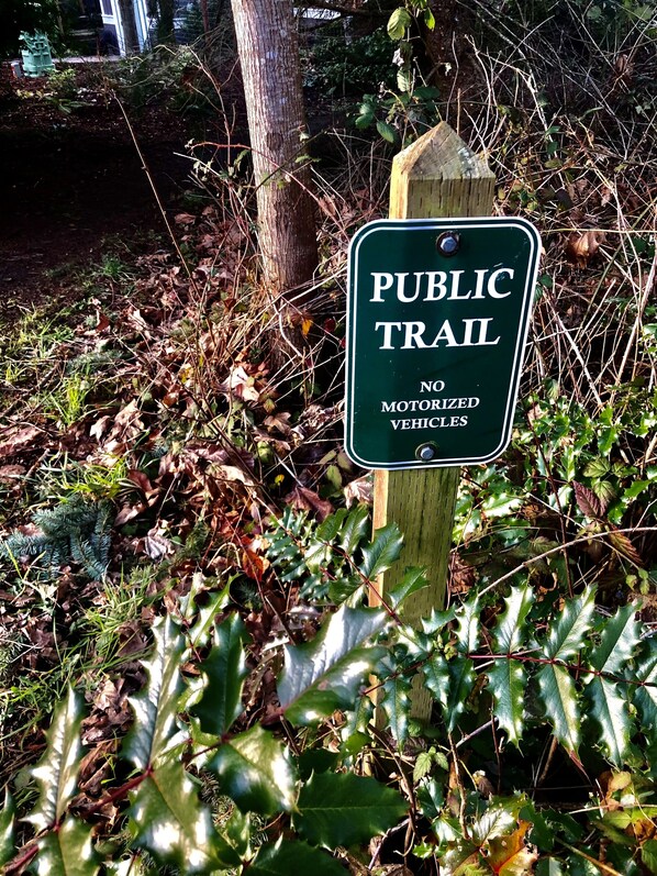 A sign indicating a public trail with a prohibition on motorized vehicles. - Walk to Fort Worden (Port Townsend)