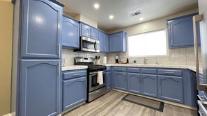 Fridge, coffee/tea maker, cookware/dishes/utensils, dining tables