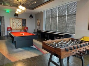 Relax and have fun in this recreational room with a pool table, foosball table, and billiards table.