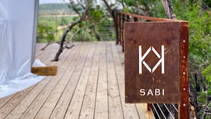 A wooden deck with a sign that reads 'SABI' and a logo.