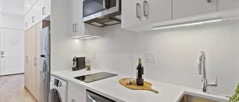A modern kitchen with stainless steel appliances, a built-in microwave, and a sink with a faucet.