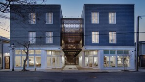 A modern two-story building with large windows and a central entrance. - The Iris Charleston (Charleston)