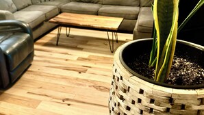 A living room with a grey sectional sofa, a wooden coffee table, and a potted plant. - Group Fun - 7 Separated Sleeping Areas! (Redmond)