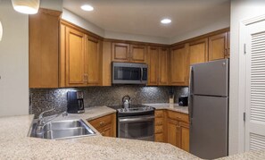 Enjoy cooking in this well-equipped kitchen with a double oven, microwave, and refrigerator.