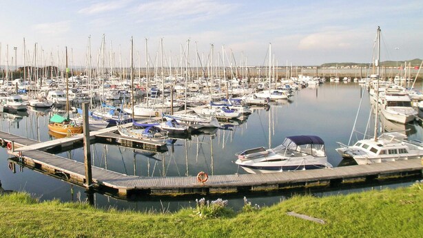 A marina with numerous boats docked at wooden piers. - 1 bedroom accommodation in Girvan (Girvan)
